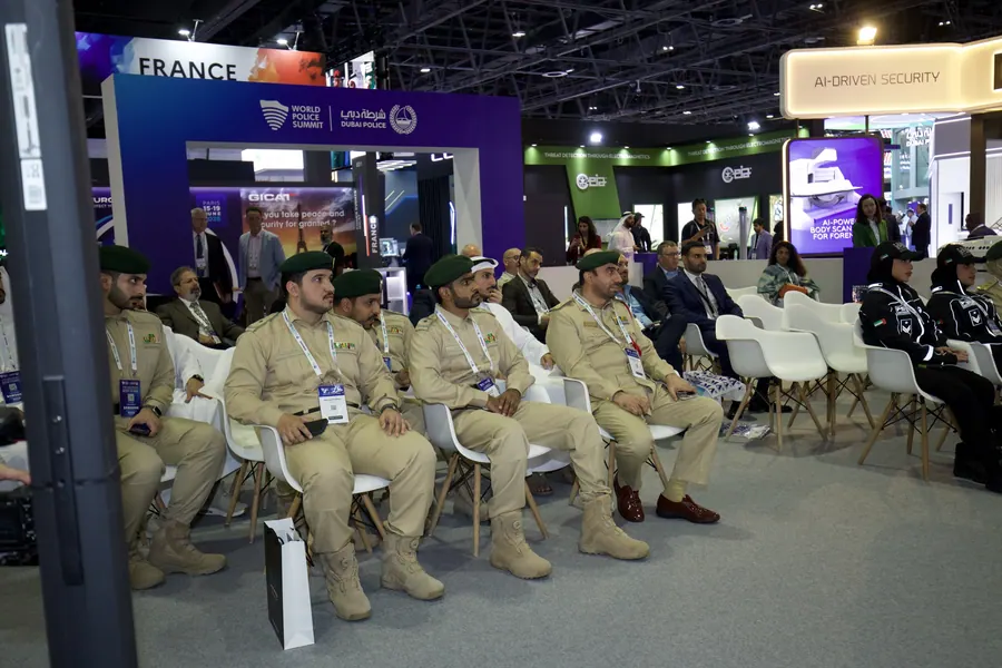 Uniformed officers seated at an arena session on the exhibition floor at the World Police Summit 2025