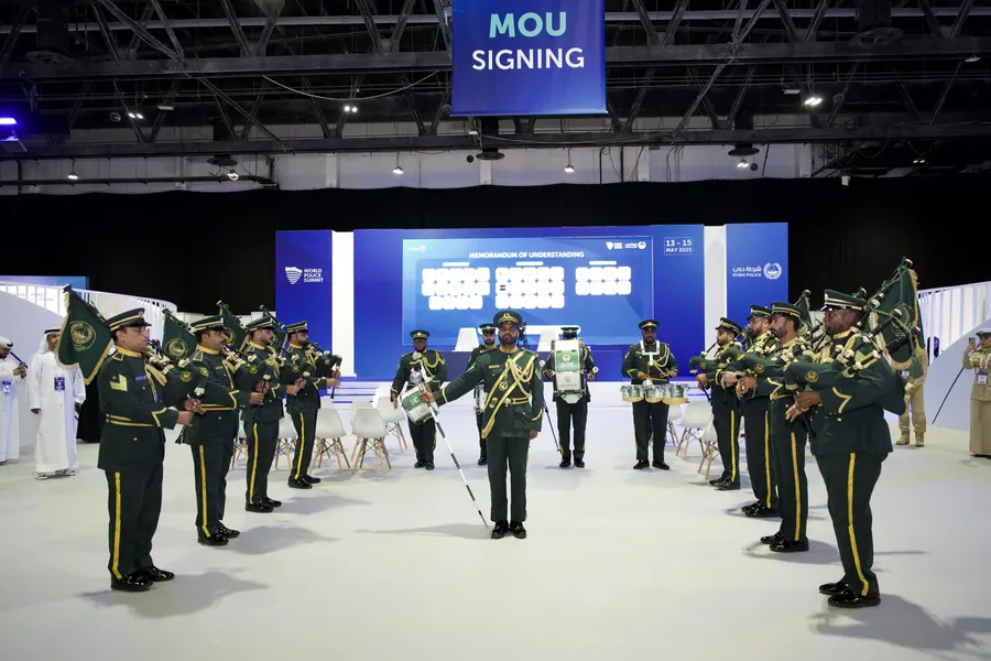 An MOU signing ceremony with a ceremonial guard present