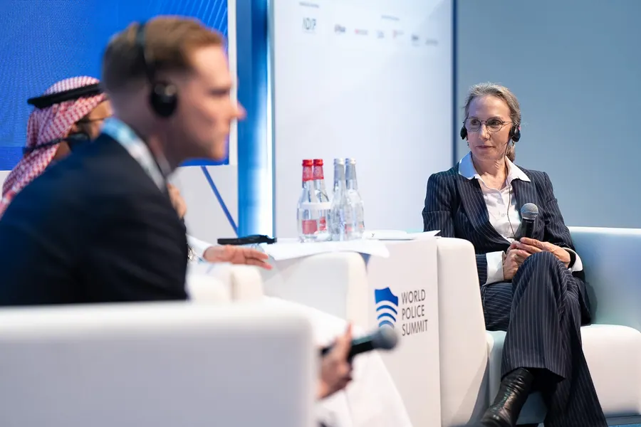 A speaker in a fireside-chat session on the World Police Summit 2025 stage
