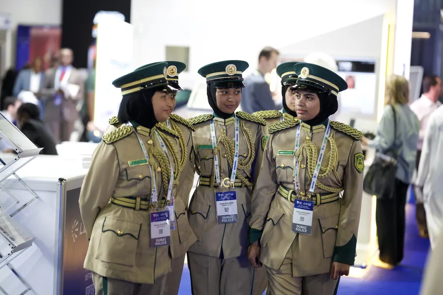 Three female Dubai Police officers at the World Police Summit 2025