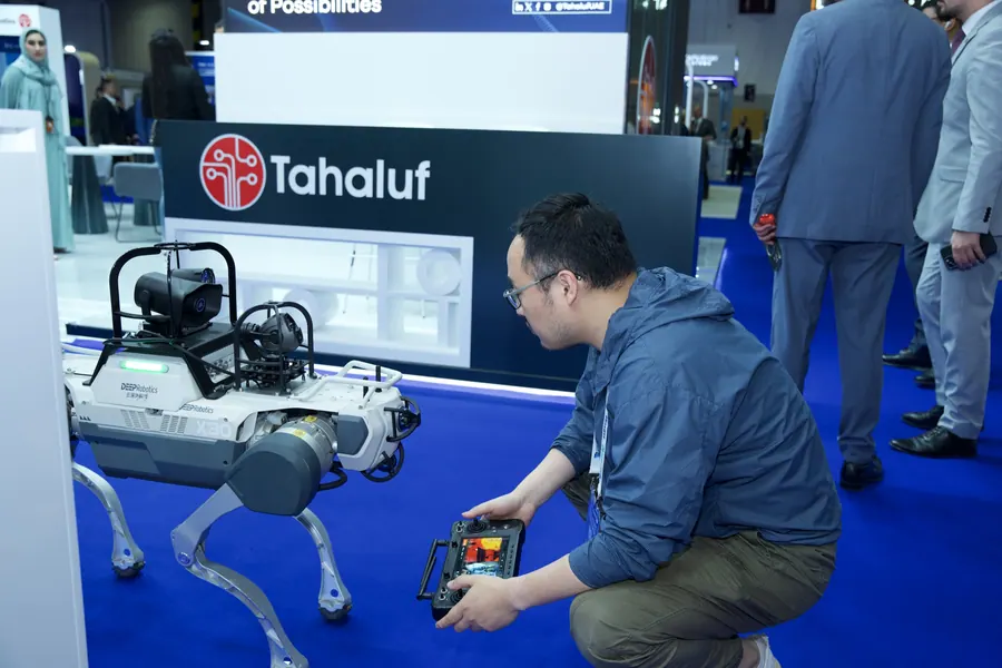 A robotic quadruped being demonstrated to visitors