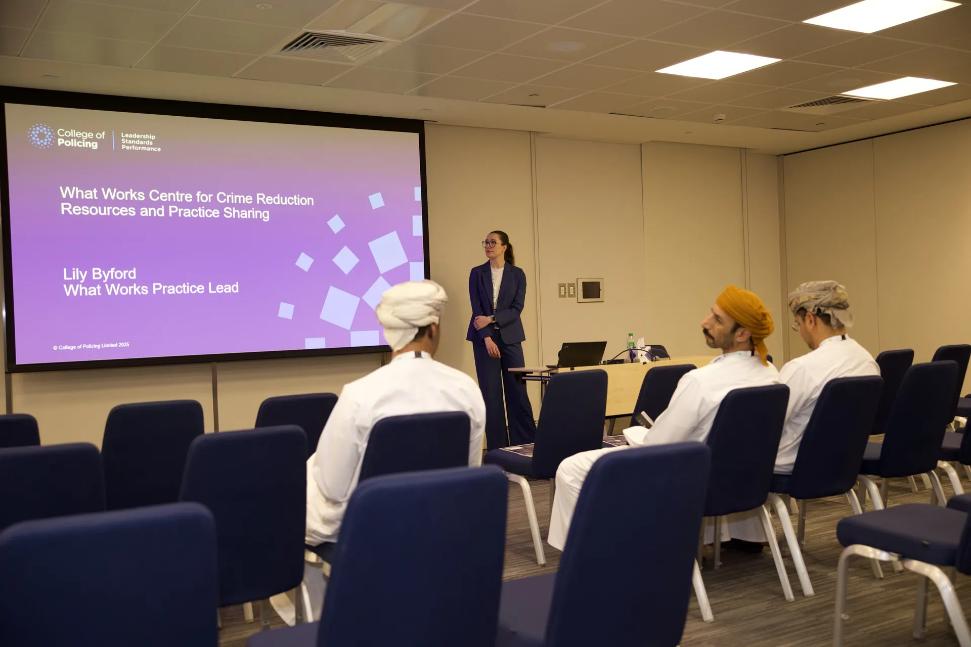 Delegates seated in a workshop room at the World Police Summit 2025 during a crime-reduction practice-sharing session
